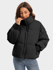 Black padded bomber jacket with high neck and ribbed cuffs.