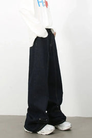 Dark denim trousers with sculptural seam details and wide leg