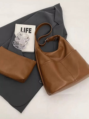 Brown leather hobo shoulder bag with adjustable strap and matching pouch.