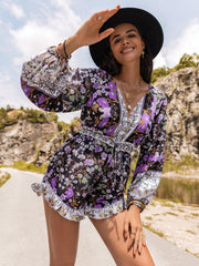 Floral print blouson sleeve romper in mauve with button front and ruffled hem.