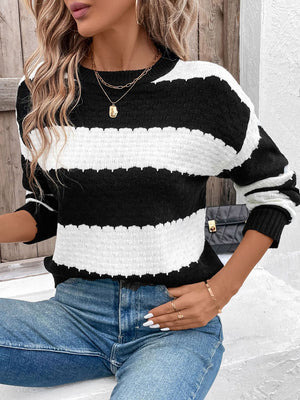 Black and white striped acrylic sweater with round neck and long sleeves.