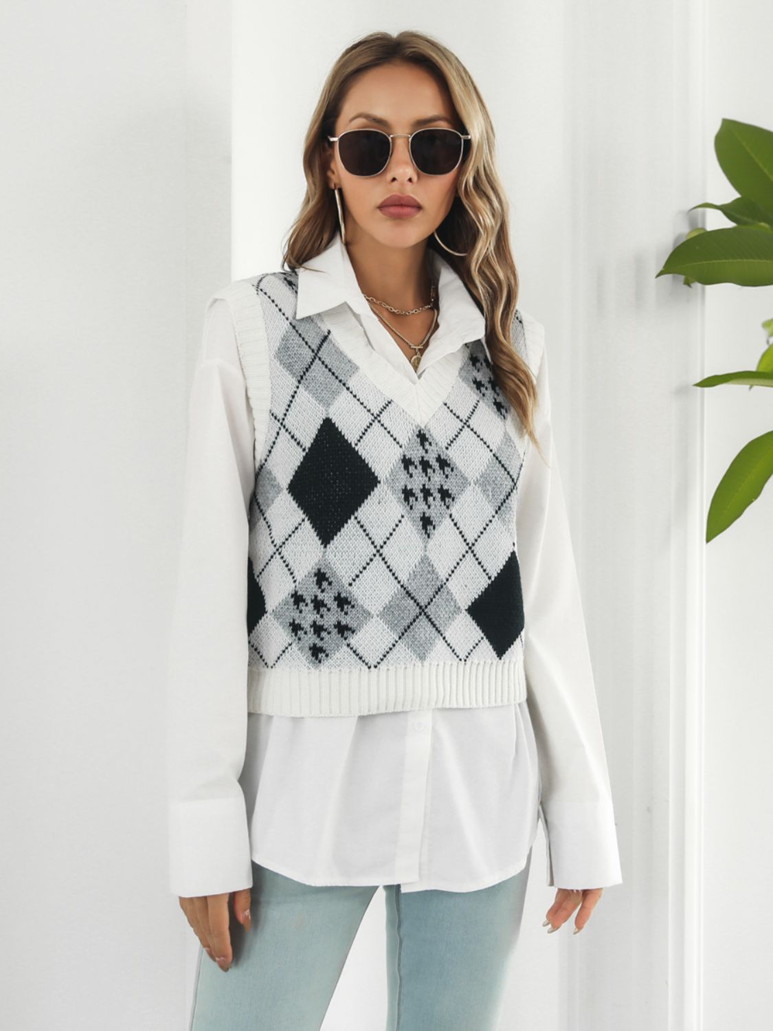 Argyle knit cropped sweater vest in white with V-neck and sleeveless design.