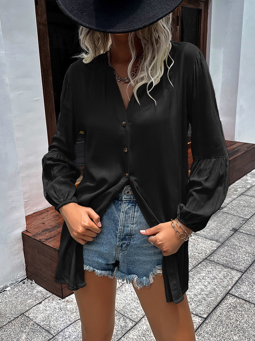 Black oversized blouse with Mandarin collar, button front, and balloon sleeves.