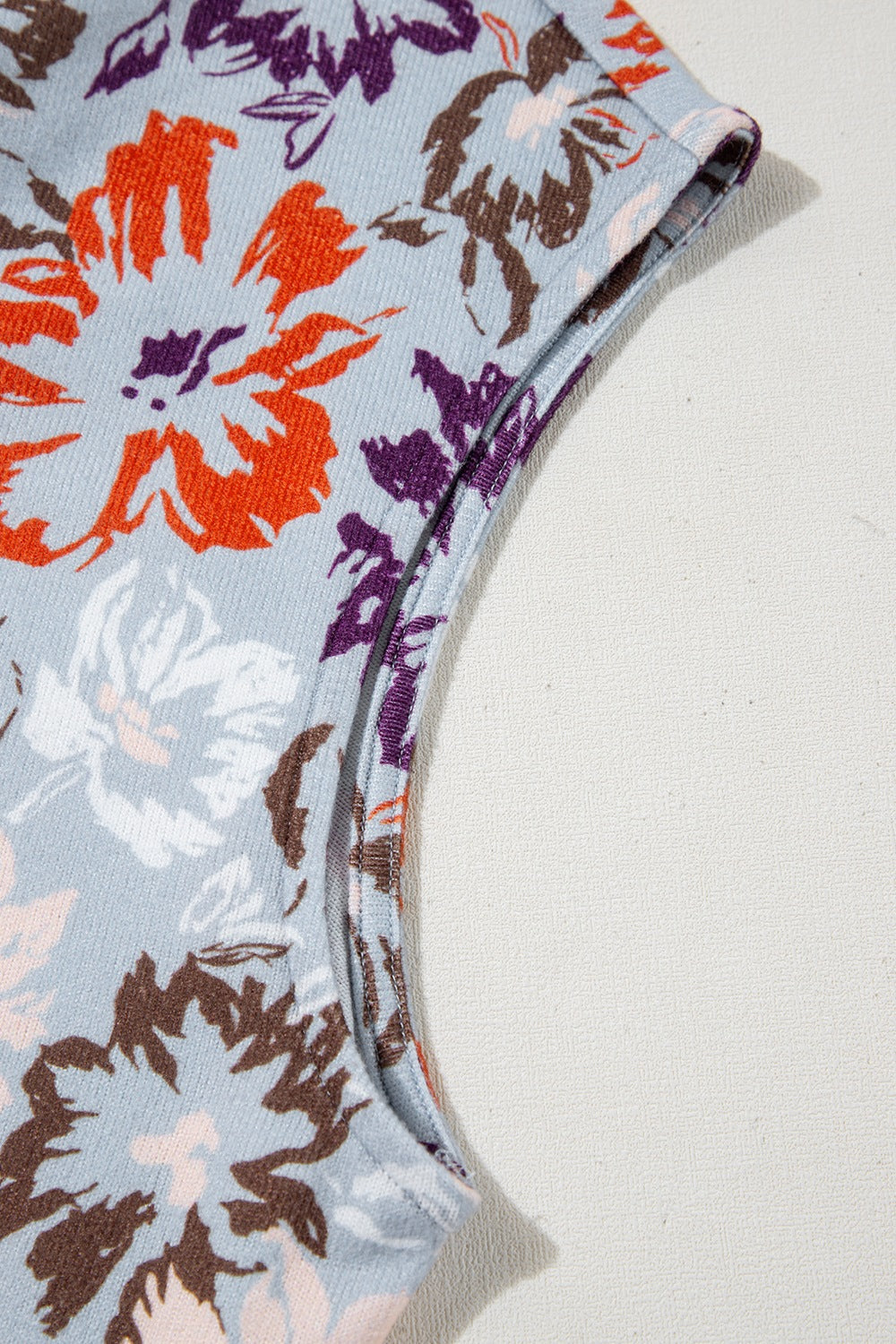 Floral cap-sleeve jumpsuit with wide legs and a colorful floral print.