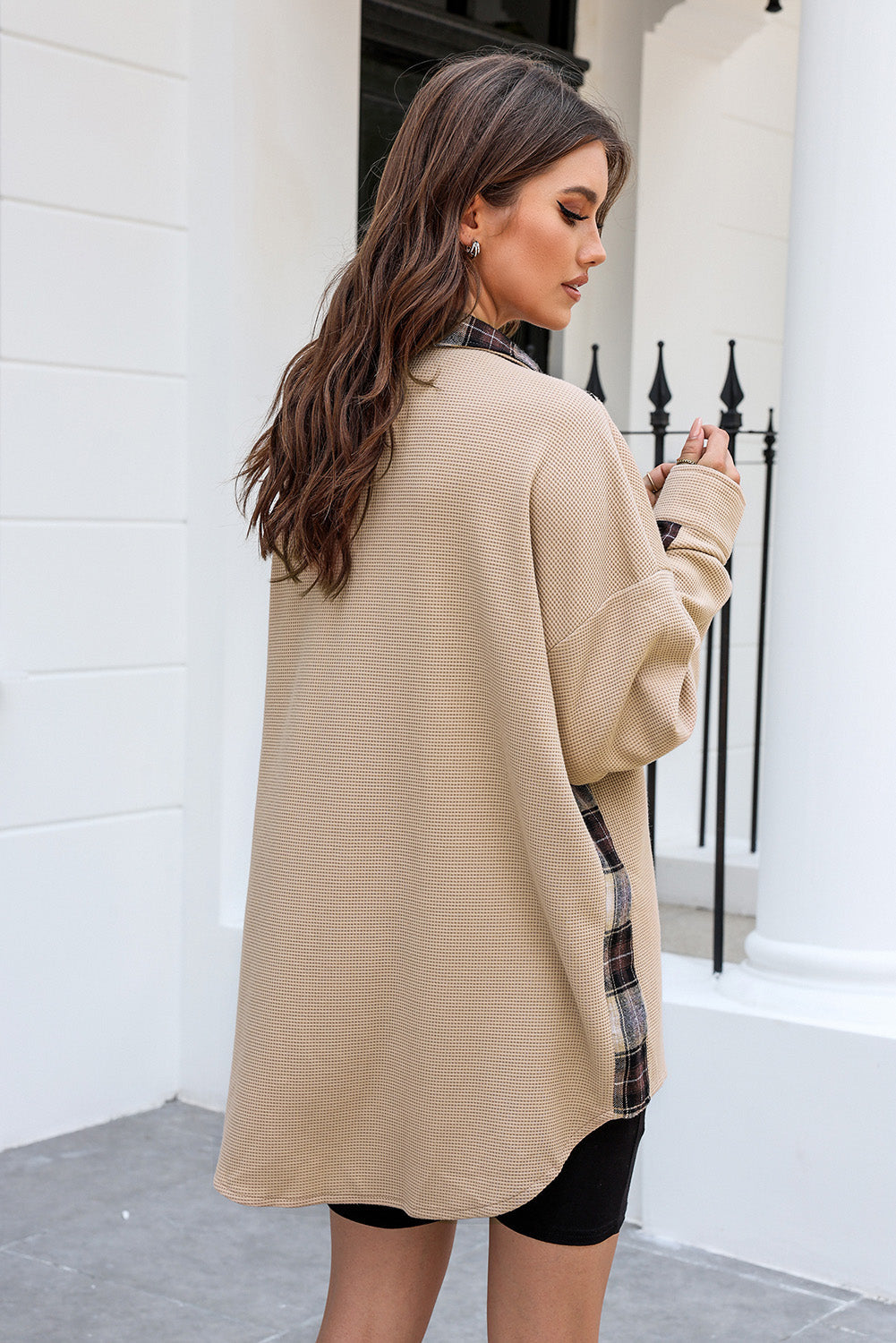 Tan waffle knit overshirt with plaid trim detail and button front, styled casually.