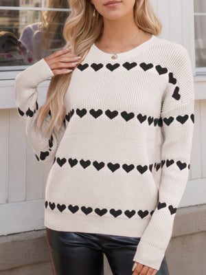 Ivory knit sweater with black heart stripes, crew neck, long sleeves.