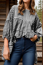 Gingham tiered blouson sleeve blouse with a round neckline and ruffled hem.
