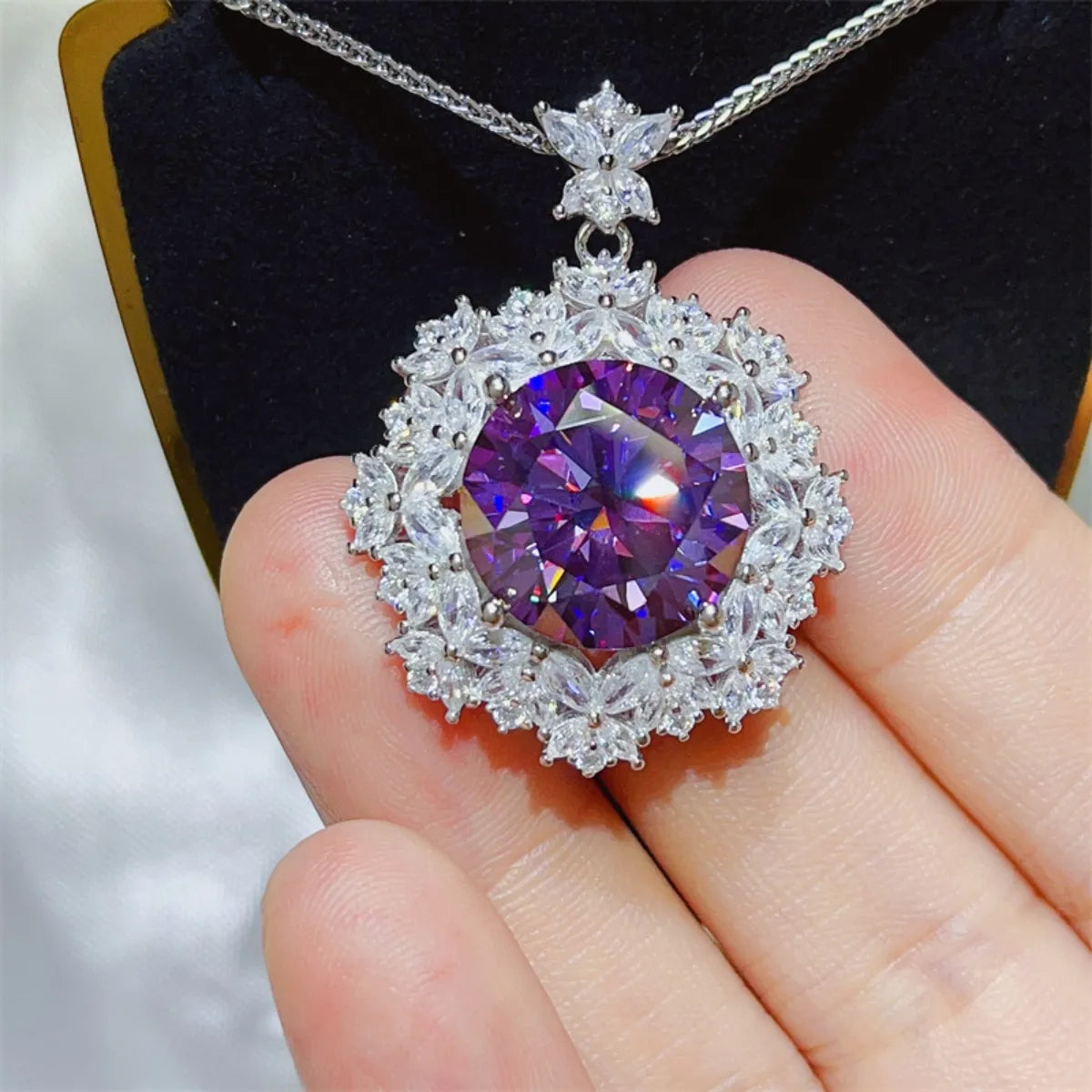 Amethyst pendant necklace with sparkling white crystal accents on a silver chain.