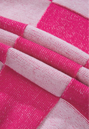 Hot pink and white checkerboard knit cardigan fabric detail