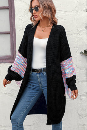 Black acrylic cardigan with textured multicolor sleeve panels and fringe detail
