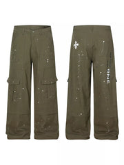 Olive green cotton cargo pants with white paint splatter design and button fly.