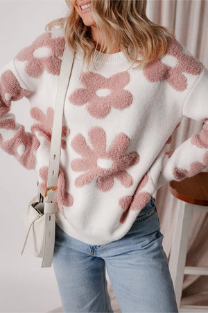 White knit pullover with textured pink floral pattern and crew neck.
