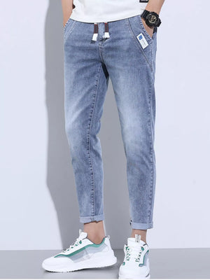Light blue washed skinny jeans with adjustable drawstring and cuffed ankles.