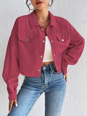 Cropped cerise corduroy snap-front jacket with chest pockets and collared neckline.
