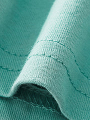 Teal cotton toddler two-piece set detail, showing fabric texture and stitching.