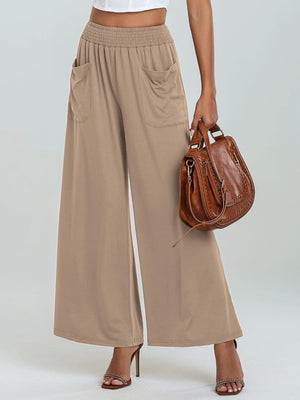 Tan elastic waist palazzo trousers with pockets and wide legs.