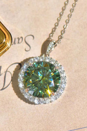 Emerald cut halo moissanite necklace in platinum with a green center stone.