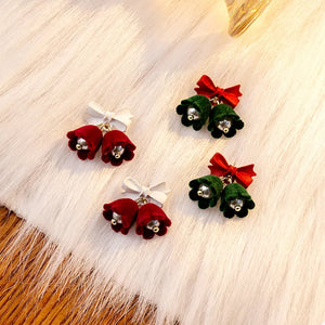 Velvet bell earrings in dark green and deep red, each with a bow detail.