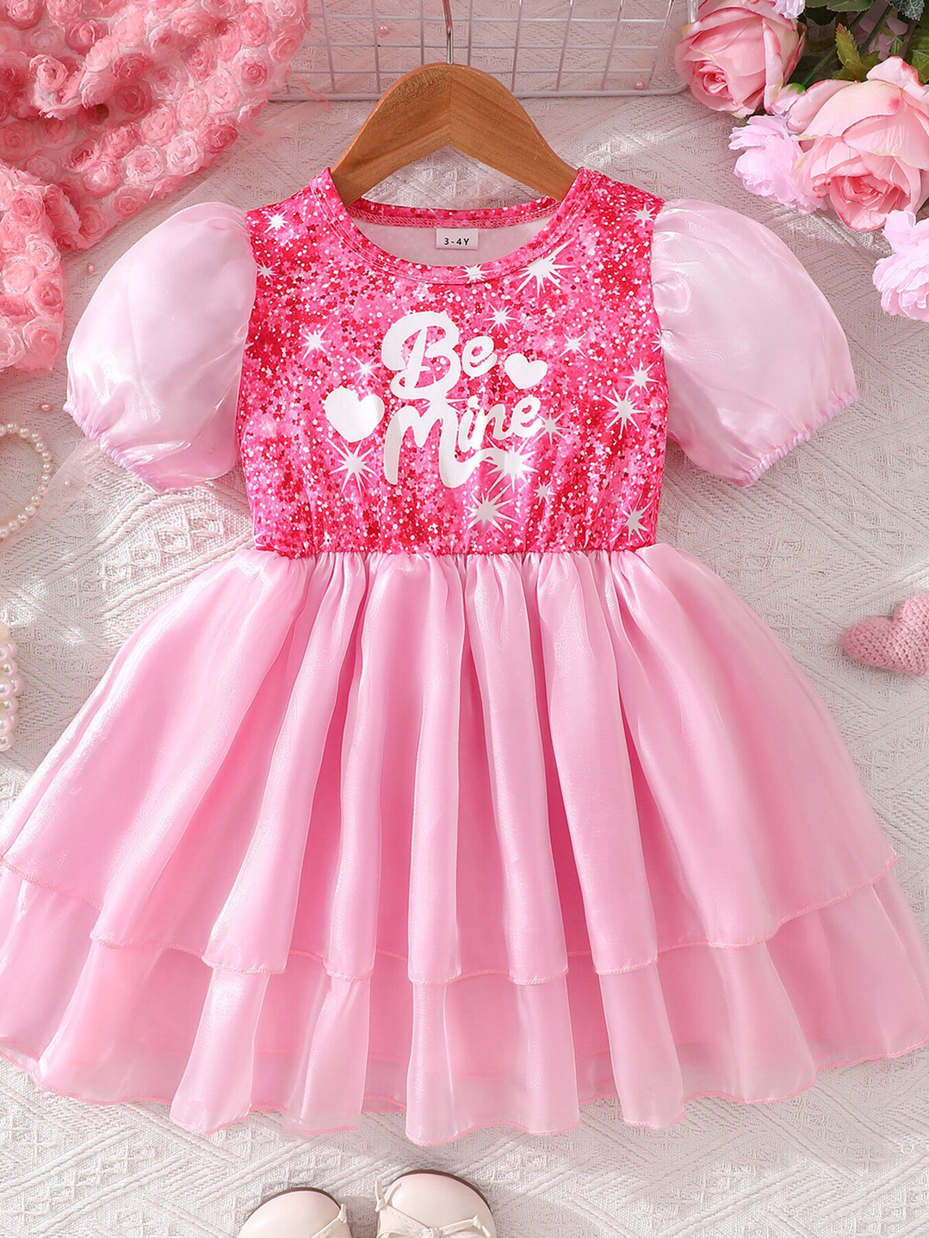 Pink sequin baby dress with puff sleeves and "Be Mine" graphic, tiered skirt.