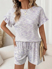 Ruffled sleeve two-piece set in white and purple textured knit with drawstring shorts.