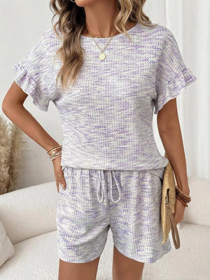 Ruffled sleeve two-piece set in white and purple textured knit with drawstring shorts.