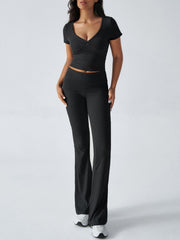 Black ruched waistband flared lounge pants and a V-neck crop top.