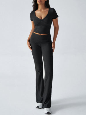 Black ruched waistband flared lounge pants and a V-neck crop top.