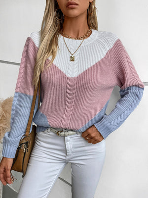 Chevron cable knit sweater in pastel blue, blush pink, and white colorblock with cable knit sleeves and neckline.