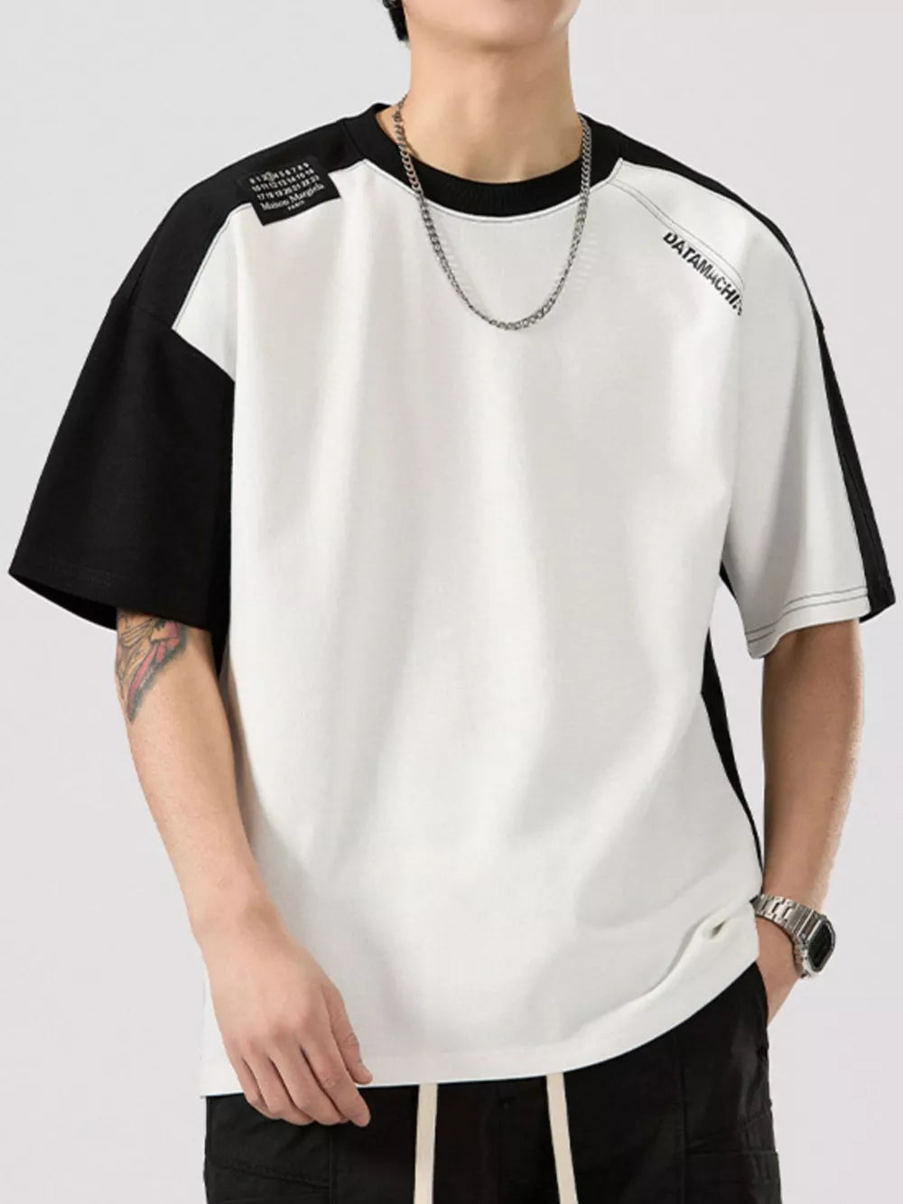 Color block t-shirt with black sleeves, round neck, cotton blend, and graphic detail.