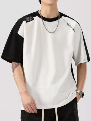 Color block t-shirt with black sleeves, round neck, cotton blend, and graphic detail.
