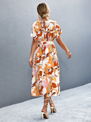 Abstract print midi dress with tie waist in orange-red and white, A-line cut, short sleeves.