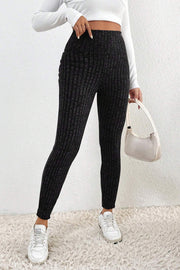 Textured knit leggings in black with vertical ribbing detail, high waist, full length.
