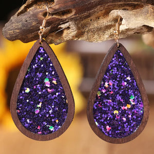 Wood-framed teardrop earrings with purple glitter inlay and gold hooks