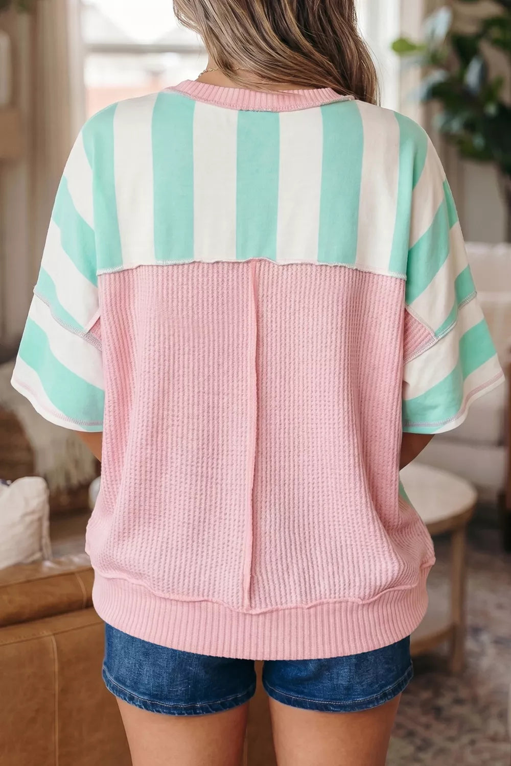 Oversized t-shirt with pastel stripes and pink waffle knit, exposed seams, short sleeves.
