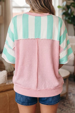 Oversized t-shirt with pastel stripes and pink waffle knit, exposed seams, short sleeves.