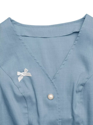 Blue buttoned vest with pearl button and polka dot bow detail