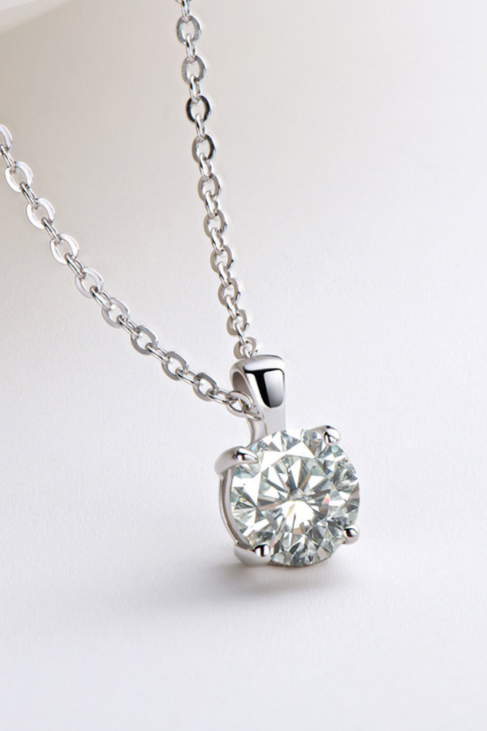 Silver solitaire pendant necklace with a round-cut diamond on a delicate chain.