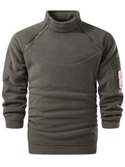 Military green fleece sweatshirt with mock neck, diagonal chest zippers, and zippered arm pocket with flag detail.