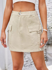 Beige denim cargo mini skirt with utility pockets and a comfortable elastic waistband.