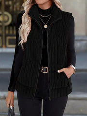 Black fleece zip-up vest with pockets and a stand-up collar.