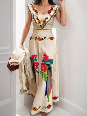 Cream maxi skirt with parrot embroidery and ruffled crop top with floral embroidery