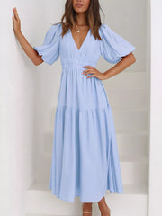 Light blue midi dress with puff sleeves, V-neck, cinched waist, and tiered skirt.