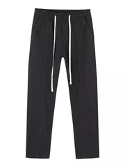 Black cotton relaxed fit jeans with drawstring waist and white drawstrings.