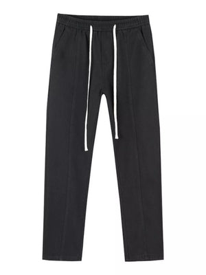 Black cotton relaxed fit jeans with drawstring waist and white drawstrings.