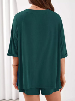 Ribbed green V-neck lounge set with cuffed short sleeves and matching shorts.
