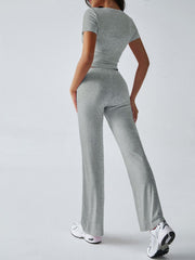 Light gray velour crop top and flared pants set with short sleeves.