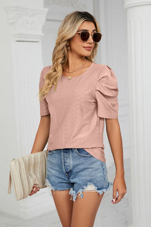 Pink perforated sleeve blouse with textured fabric and scoop neck.