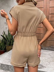 Camel utility romper with tie-waist detail, collared, short sleeves, and cuffed shorts.