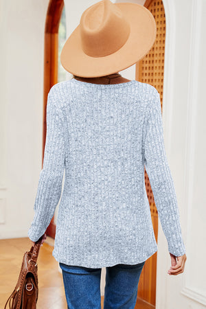 Light blue ribbed knit top with long sleeves and a scoop neck, featuring eyelet shoulder detail.