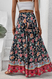 Floral border palazzo trousers with a wide leg and tiered hem, styled with a white crop top.